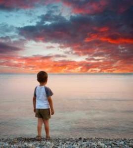 Little boy on beach at sunset